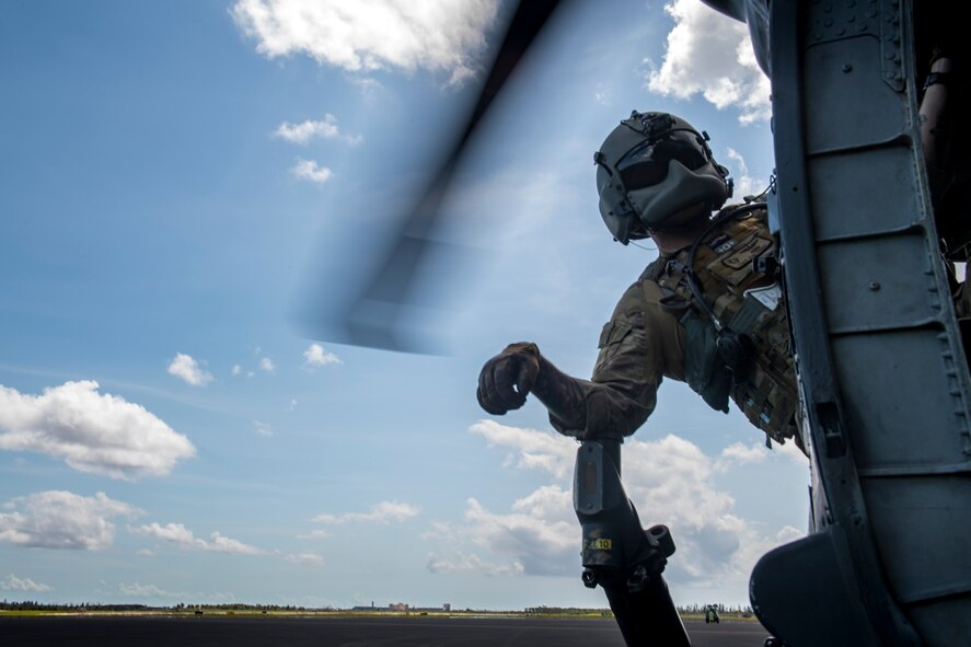 Tech. Sgt. Tom Perry, 66th Rescue Squadron special missions aviator, watches the rotors of an HH-60G Pave Hawk spin up, Sept. 12, 2017, at Homestead Air Reserve Base, Fla. The 563d Rescue Group prepositioned aircraft and personnel for rescue operations in support of FEMA and U.S. Northern Command after Hurricane Irma made landfall in Florida. (U.S. Air Force photo by Tech. Sgt. Zachary Wolf)