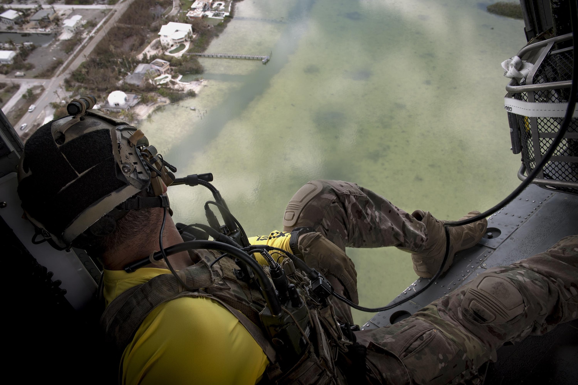 A pararescueman from the 48th Rescue Squadron scans the ground from an HH-60G Pave Hawk, Sept. 12, 2017, in the skies over South Florida. The 563d Rescue Group prepositioned aircraft and personnel in support of FEMA and U.S. Northern Command for rescue operations after Hurricane Irma made landfall in Florida. (U.S. Air Force photo by Staff Sgt. Ryan Callaghan)