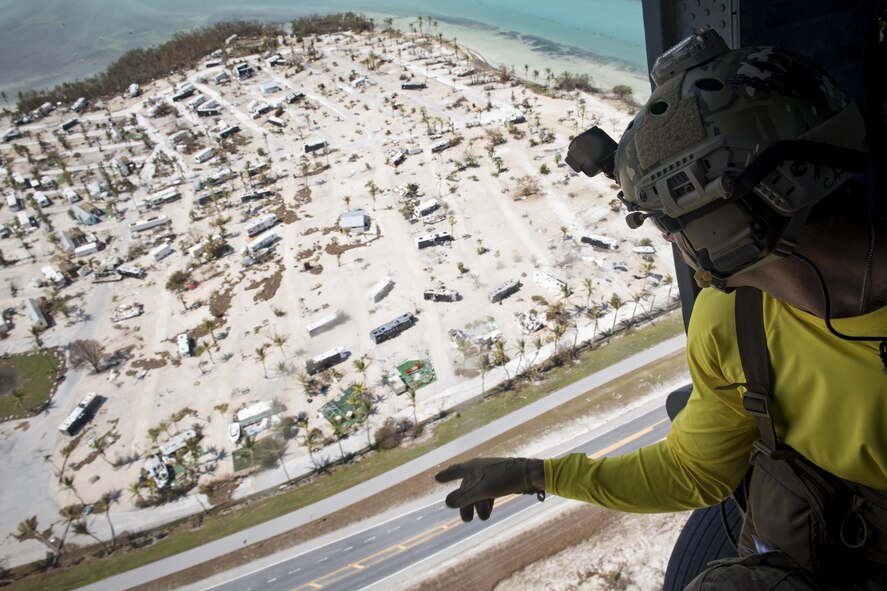 A pararescueman from the 48th Rescue Squadron scans the ground from an HH-60G Pave Hawk, Sept. 12, 2017, in the skies over South Florida. The 563d Rescue Group prepositioned aircraft and personnel in support of FEMA and U.S. Northern Command for rescue operations after Hurricane Irma made landfall in Florida. (U.S. Air Force photo by Staff Sgt. Ryan Callaghan)