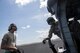 Tech. Sgt. Tom Perry, 66th Rescue Squadron special missions aviator, and an airman from the 923d Maintenance Squadron, watch the rotors of an HH-60G Pave Hawk spin, Sept. 12, 2017, at Homestead Air Reserve Base, Fla. The 563d Rescue Group prepositioned aircraft and personnel for rescue operations in support of FEMA and U.S. Northern Command after Hurricane Irma made landfall in Florida. (U.S. Air Force photo by Tech. Sgt. Zachary Wolf)