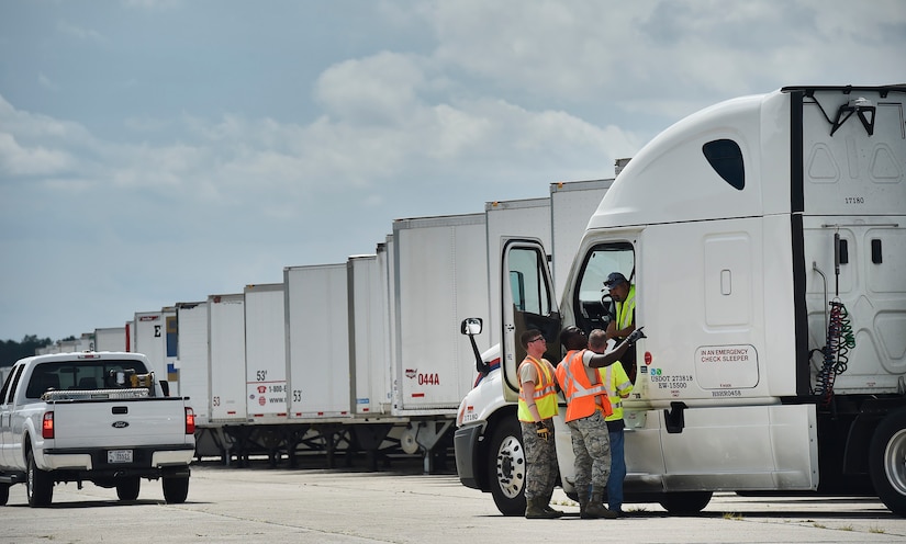 Airmen of the 43rd Air Mobility Operations Group, Pope Army Airfield, N.C., and the U.S. Department of Homeland Security - Federal Emergency Management Agency (FEMA), direct truck drivers transporting goods and commodities in support of Hurricane Irma relief efforts at Joint Base Charleston’s North Auxiliary Airfield, S.C., Sept. 13, 2017. The airfield acts as a receiving and distribution staging area for goods and commodities to be transported to hurricane victims here and areas to the southeast over the next few weeks. Airmen of the 43rd AMOG and FEMA are working side-by-side executing relief efforts. (U.S. Air Force photo by Staff Sgt. Christopher Hubenthal)