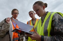 From left to right, Sonia Hancock, U.S. Department of Homeland Security - Federal Emergency Management Agency (FEMA) logistics specialist, goes over paperwork with First Lt. Savannah Emmrich, 43rd Air Base Squadron fuels management officer in charge, and Senior Airman Haley Bradshaw, 43rd ABS personnelist, both assigned to Pope Army Airfield, N.C., at Joint Base Charleston’s North Auxiliary Airfield, S.C., Sept. 13, 2017. The airfield acts as a receiving and distribution staging area for goods and commodities being transported to hurricane victims here and areas to the southeast over the next few weeks. Airmen of the 43rd Air Mobility Operations Group and FEMA are working side-by-side executing relief efforts. (U.S. Air Force photo by Staff Sgt. Christopher Hubenthal)