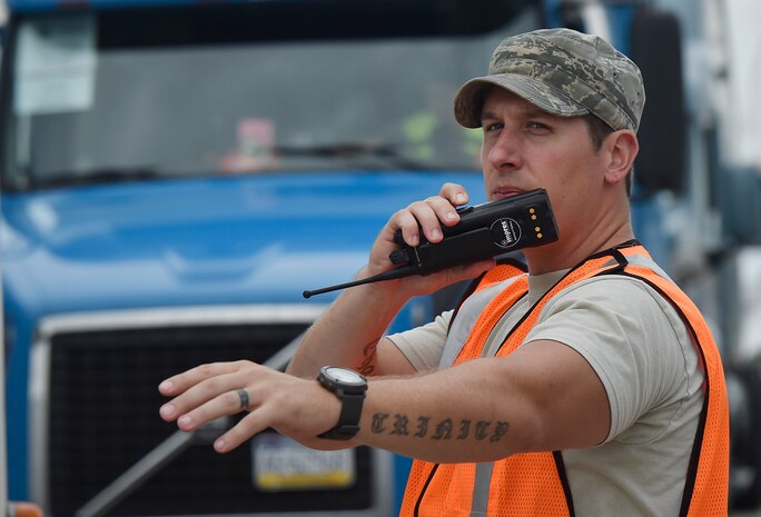 Staff Sgt. Micah Hallman, 43rd Air Mobility Squadron air transportation specialist, Pope Army Airfield, N.C., directs the movement of trucks transporting goods prepped to support Hurricane Irma relief efforts at Joint Base Charleston’s North Auxiliary Airfield, S.C., Sept. 13, 2017. The airfield acts as a receiving and distribution staging area for goods and commodities being transported to hurricane victims here and areas to the southeast over the next few weeks. Airmen of the 43rd Air Mobility Operations Group and U.S. Department of Homeland Security - Federal Emergency Management Agency (FEMA), are working side-by-side executing relief efforts. (U.S. Air Force photo by Staff Sgt. Christopher Hubenthal)