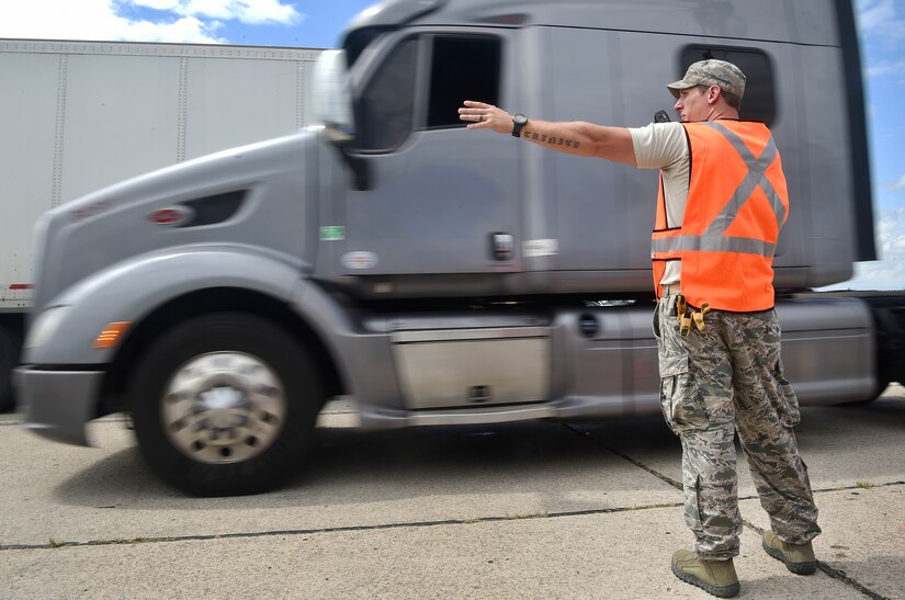 Staff Sgt. Micah Hallman, 43rd Air Mobility Squadron air transportation specialist, Pope Army Airfield, N.C., directs the movement of trucks transporting goods prepped to support Hurricane Irma relief efforts at Joint Base Charleston’s North Auxiliary Airfield, S.C., Sept. 13, 2017. The airfield acts as a receiving and distribution staging area for goods and commodities being transported to hurricane victims here and areas to the southeast over the next few weeks. Airmen of the 43rd Air Mobility Operations Group and U.S. Department of Homeland Security - Federal Emergency Management Agency (FEMA), are working side-by-side executing relief efforts. (U.S. Air Force photo by Staff Sgt. Christopher Hubenthal)