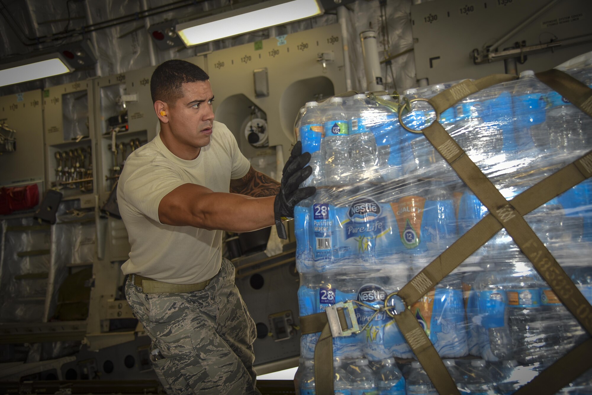 U.S. Air Force Senior Airman Allan Canizales assigned to the 6th Logistics Readiness Squadron, prepares a pallet of water to be offloaded at MacDill Air Force Base, Fla., Sept. 12, 2017.