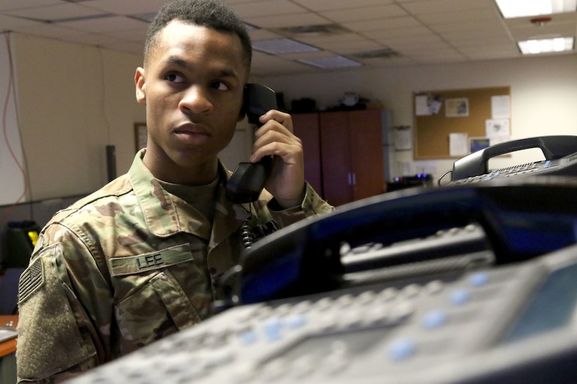 Army Spc. Christopher Lee, an Air Defense Battle Management System Operator with Headquarters and Headquarters Battery, 35th Air Defense Artillery Brigade, answers the phone at the Fire Direction Center.