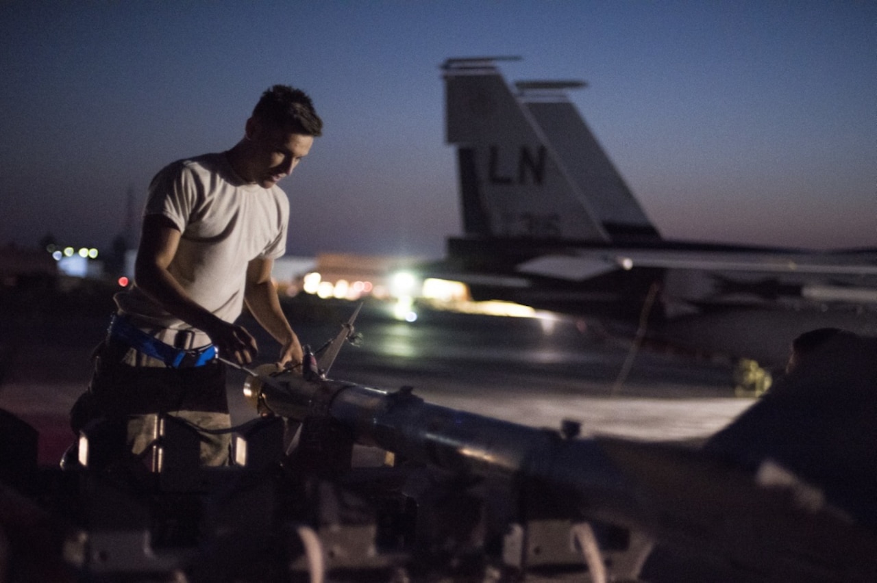 Air Force Airman 1st Class Pedro Curiel-Lamas, 332nd Expeditionary Maintenance Squadron weapons load crew member, prepares a missile
