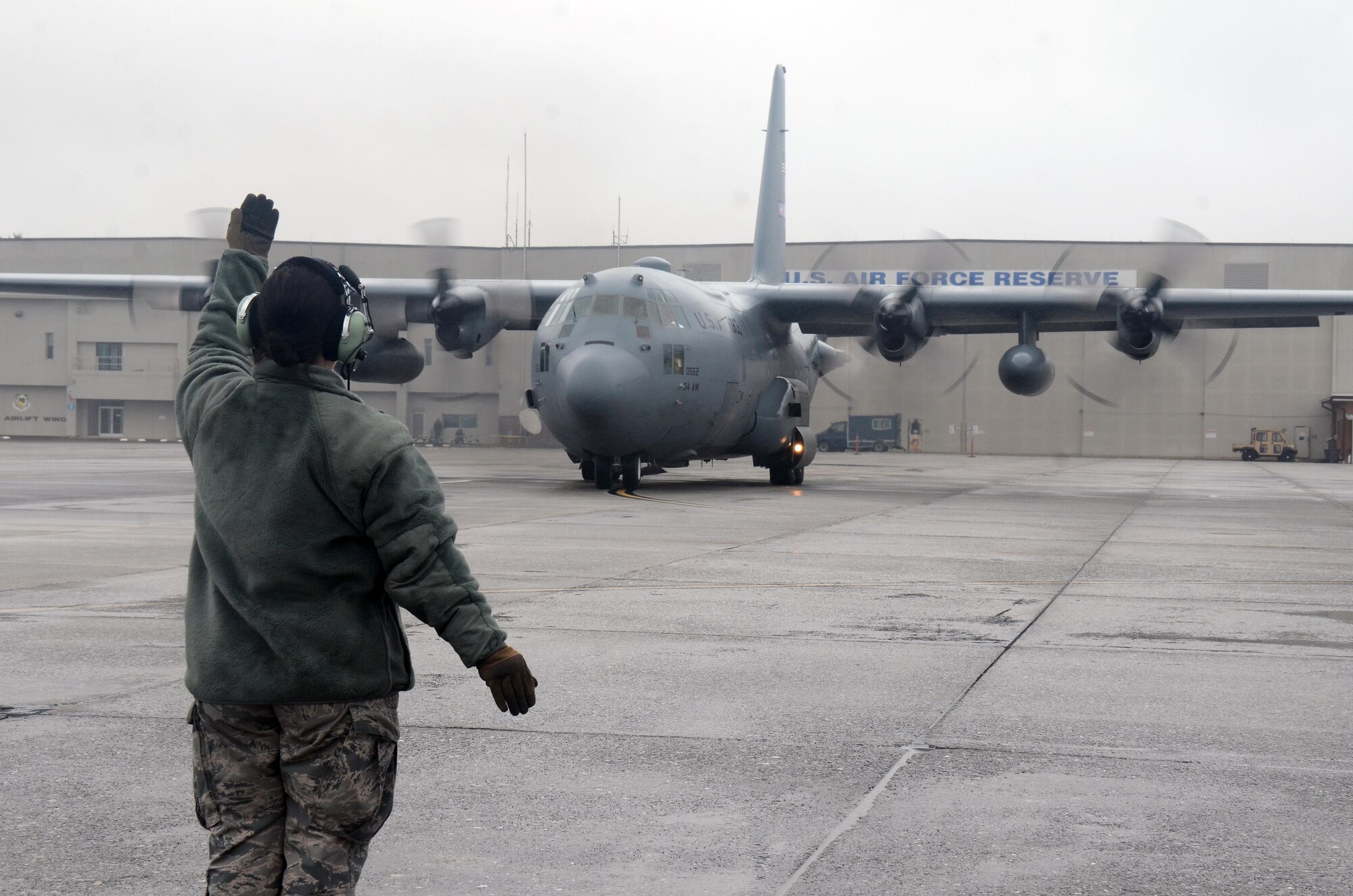 An Airman guides a C-130H3 Hercules as it taxis on the runway at Dobbins Air Reserve Base, Ga. Sept. 12, 2017. Reserve Citizen Airmen of the 700th Airlift Squadron delivered supplies and personnel to Homestead Air Reserve Base, Florida, to assist relief and reconstitution operations at the installation and in the local South Florida community. (U.S. Air Force photo/Don Peek)
