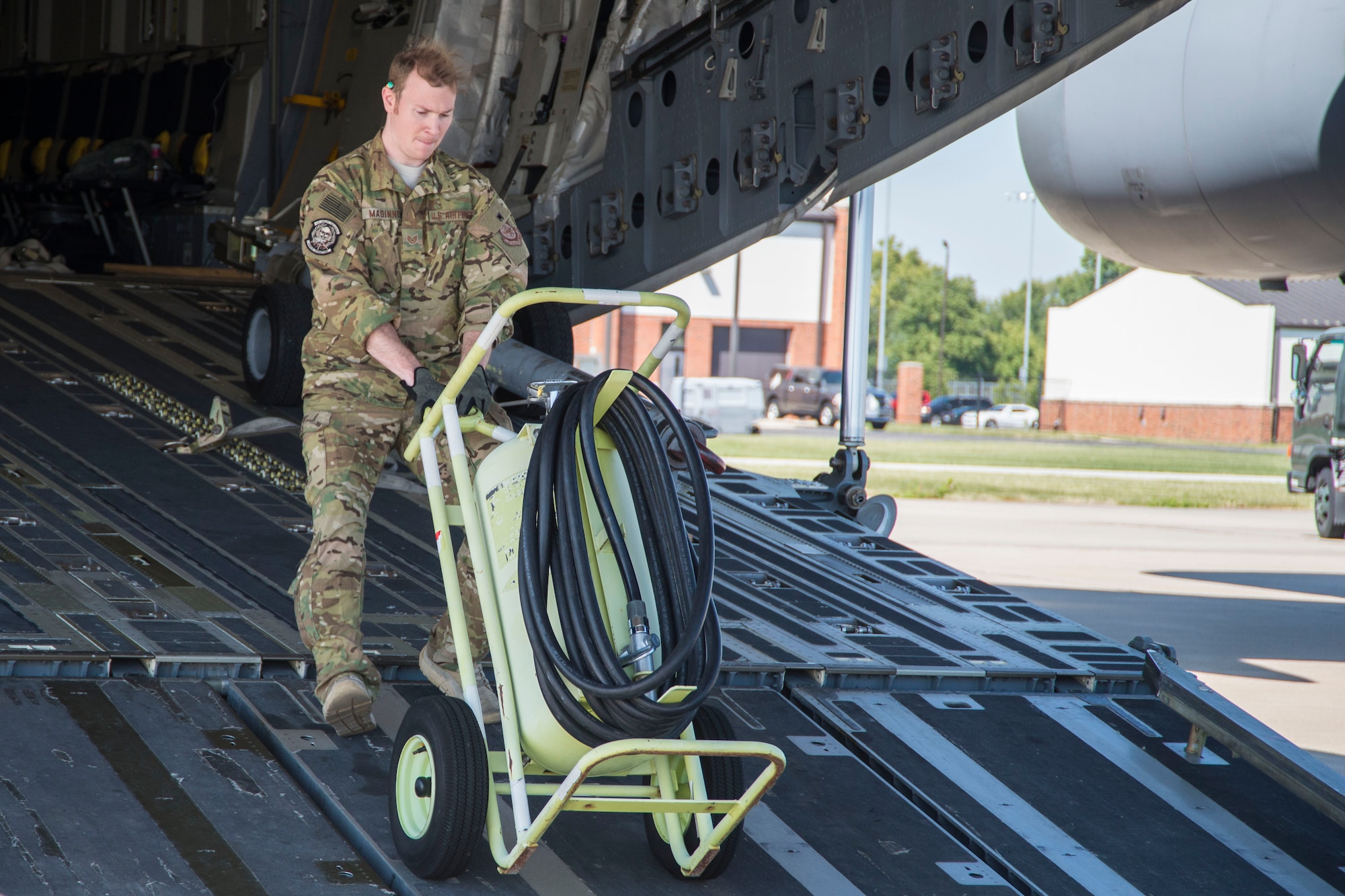 A member from Joint Base Charleston, S.C. unloads equipment from a C-17 Globemaster III in preparation for Hurricane Irma, at Scott Air Force Base, Ill