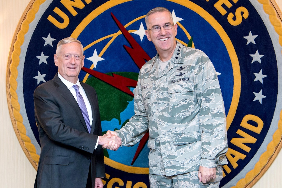 Defense Secretary Jim Mattis shakes hands with an Air Force general.