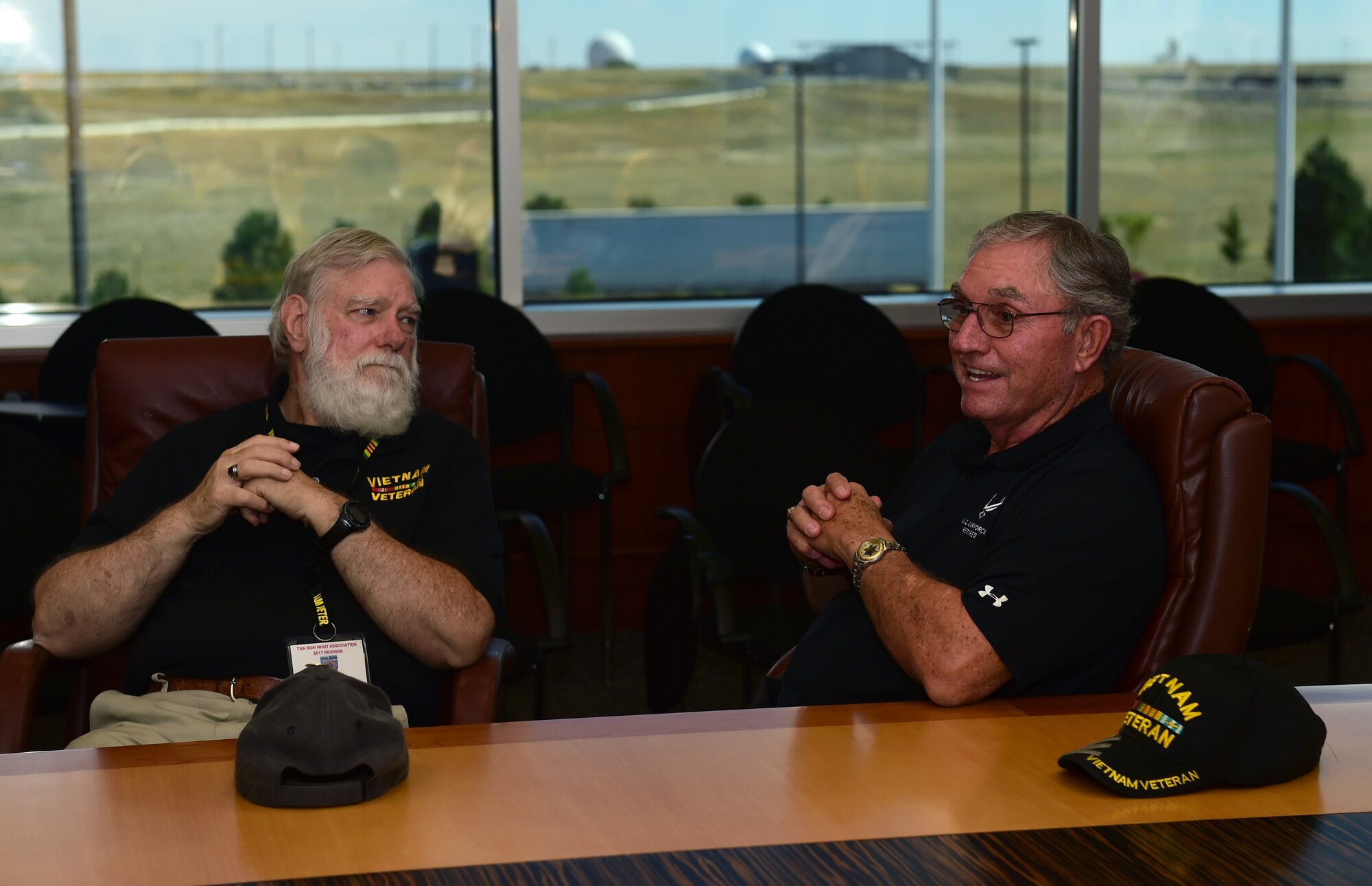 Jim Faulkner, Tan Son Nhut Association member, and Richard Carvell, Tan Son Nhut Association vice president, speak during a history briefing Sept. 14, 2017, in the 460th Headquarters building on Buckley Air Force Base, Colo.