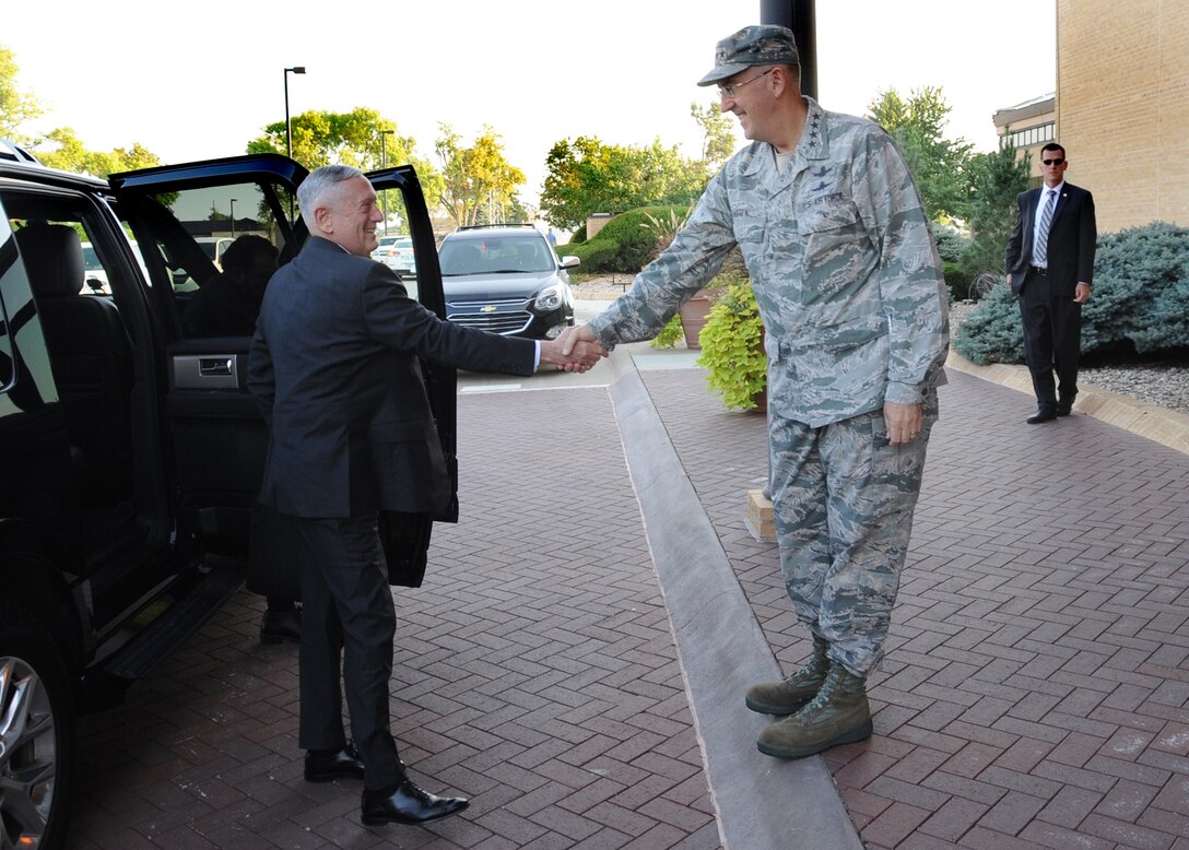 Secretary of Defense Jim Mattis (center) is greeted by U.S. Air Force Gen. John. E. Hyten, commander of U.S. Strategic Command (USSTRATCOM), upon his arrival at Offutt Air Force Base, Neb., Sept. 13, 2017.