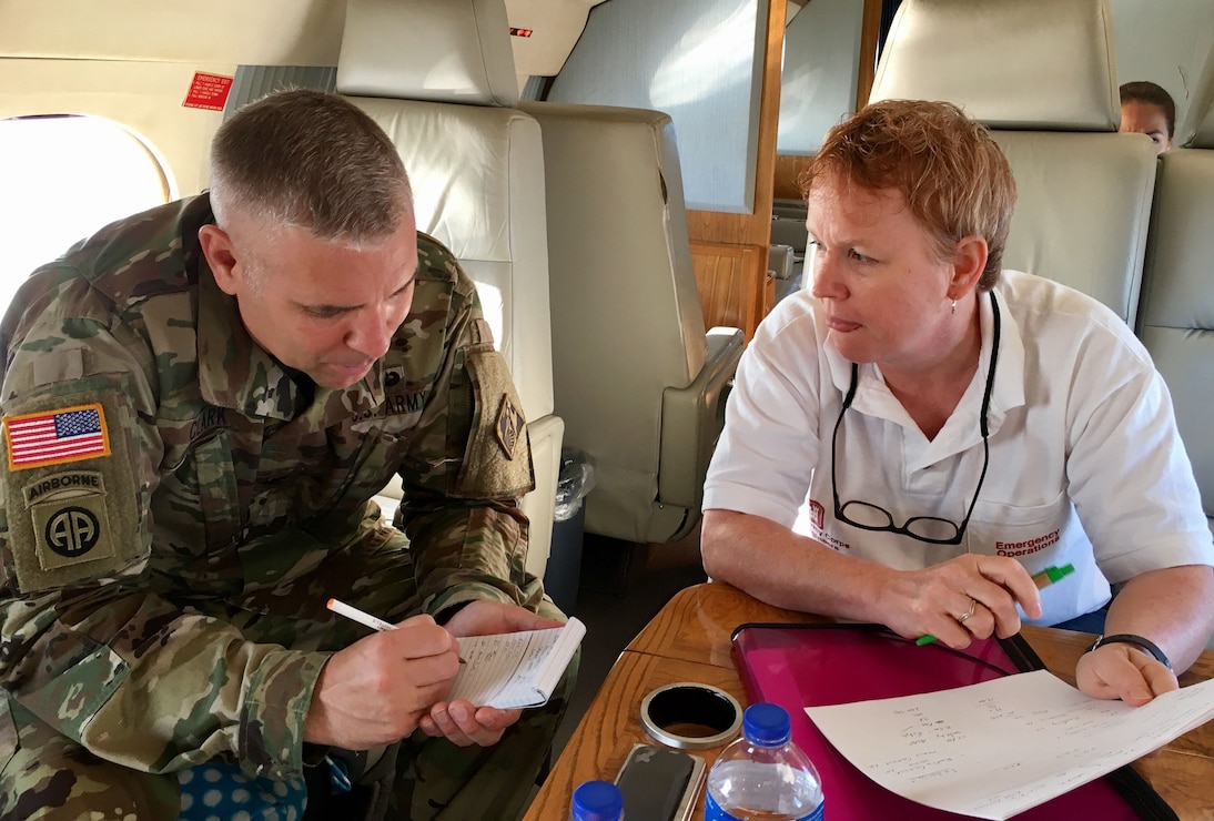 Wilmington District Commander Col. Robert Clark and the District's Chief of Emergency Operations, Janelle Mavis, discuss recovery efforts while en route to the U.S. Virgin Islands. (USACE photo by Angela Zephier)