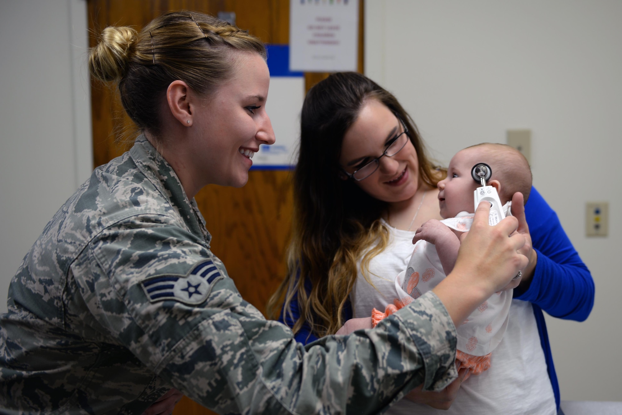 Senior Airman Taylor Scherff, 55th Medical Group Pediatric Clinic medical technician, takes Isabelle Kittel’s temperature as her mom, Casey, holds her in the Ehrling Berquist Clinic, Offutt Air Force Base, Neb., Sept. 12, 2017. (U.S. Air Force photo by Tech. Sgt. Rachelle Blake)