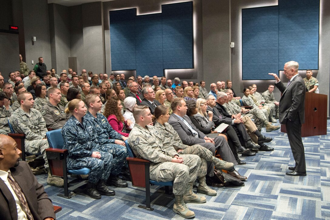 Defense Secretary Jim Mattis speaks to a room of service members and civilians.