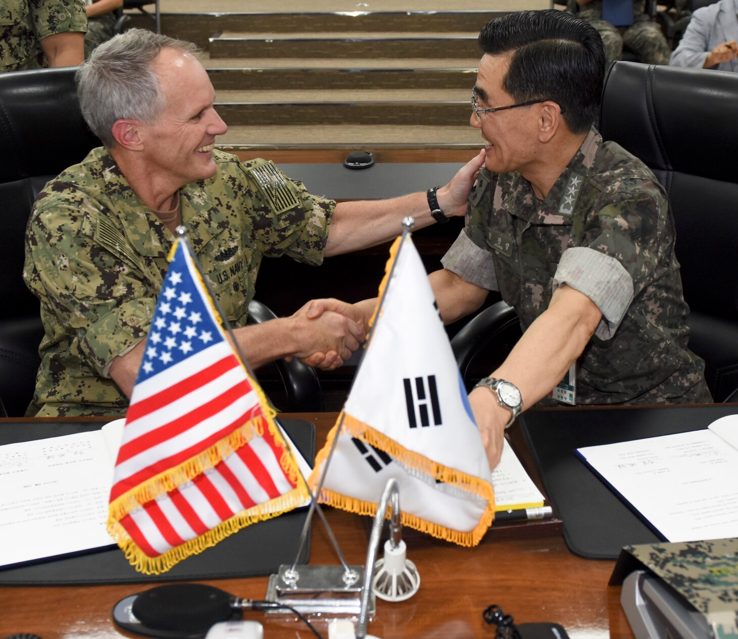 BUSAN, Republic of Korea (Sept. 14, 2017) Vice Adm. Phil Sawyer, commander, U.S. Seventh Fleet, and Vice Adm. Jung, Jin-Sup, commander, Republic of Korea (ROK) Fleet, shake hands after signing a memorandum of understanding that strengthens the relationship between the U.S. and ROK navies. Sawyer's visit included meetings with U.S. and ROK military leaders as well as the signing of a component-level MOU with the ROK navy to enhance coordination and training in support of the U.S.- ROK Alliance.
