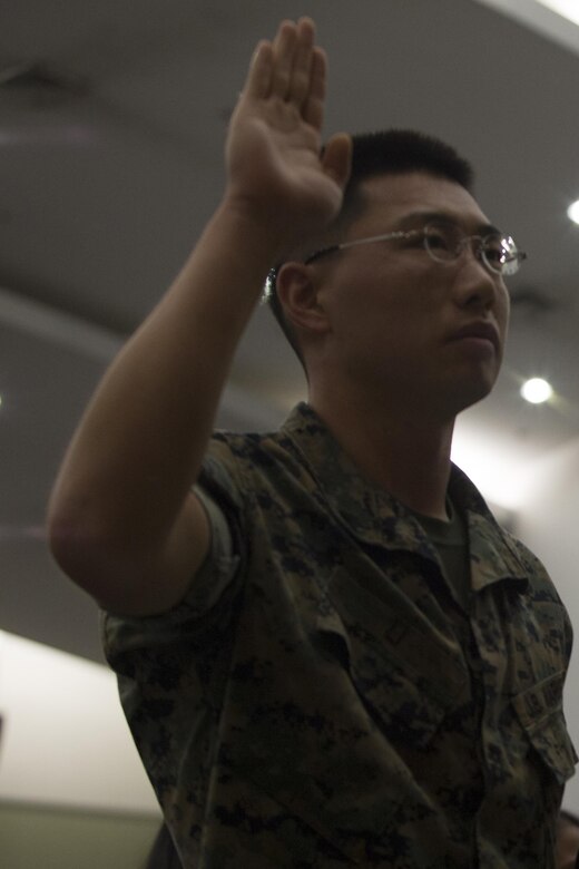 CAMP FOSTER, OKINAWA, Japan—Cpl. Bohou Li takes an “Oath of Allegiance” during a Naturalization Ceremony Sept. 13 in the base theater aboard Camp Foster, Okinawa, Japan.