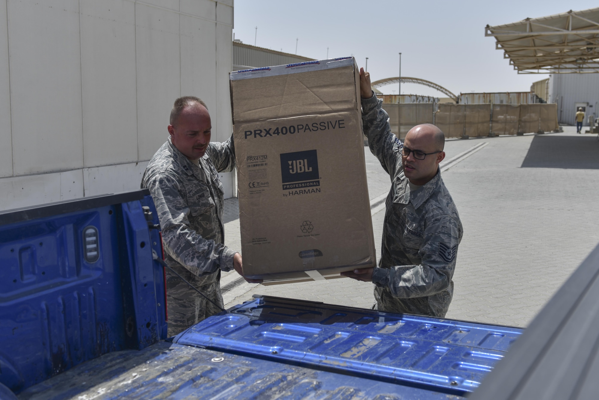 Chaplain (Capt.) James Longe, left, and chaplain's assistant Tech. Sgt. Siddartha Sosa-Rodriguez load a box of donated goods into a truck at Al Dhafra Air Base, United Arab Emirates, Sept. 8, 2017.