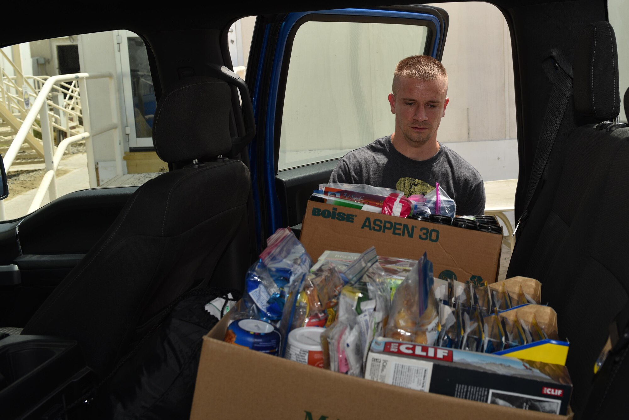 Tech. Sgt. Adam Martin, vehicle maintenance technician with the 380th Expeditionary Logistics Readiness Squadron, loads boxes of donated goods into a truck at Al Dhafra Air Base, United Arab Emirates, Sept. 8, 2017.