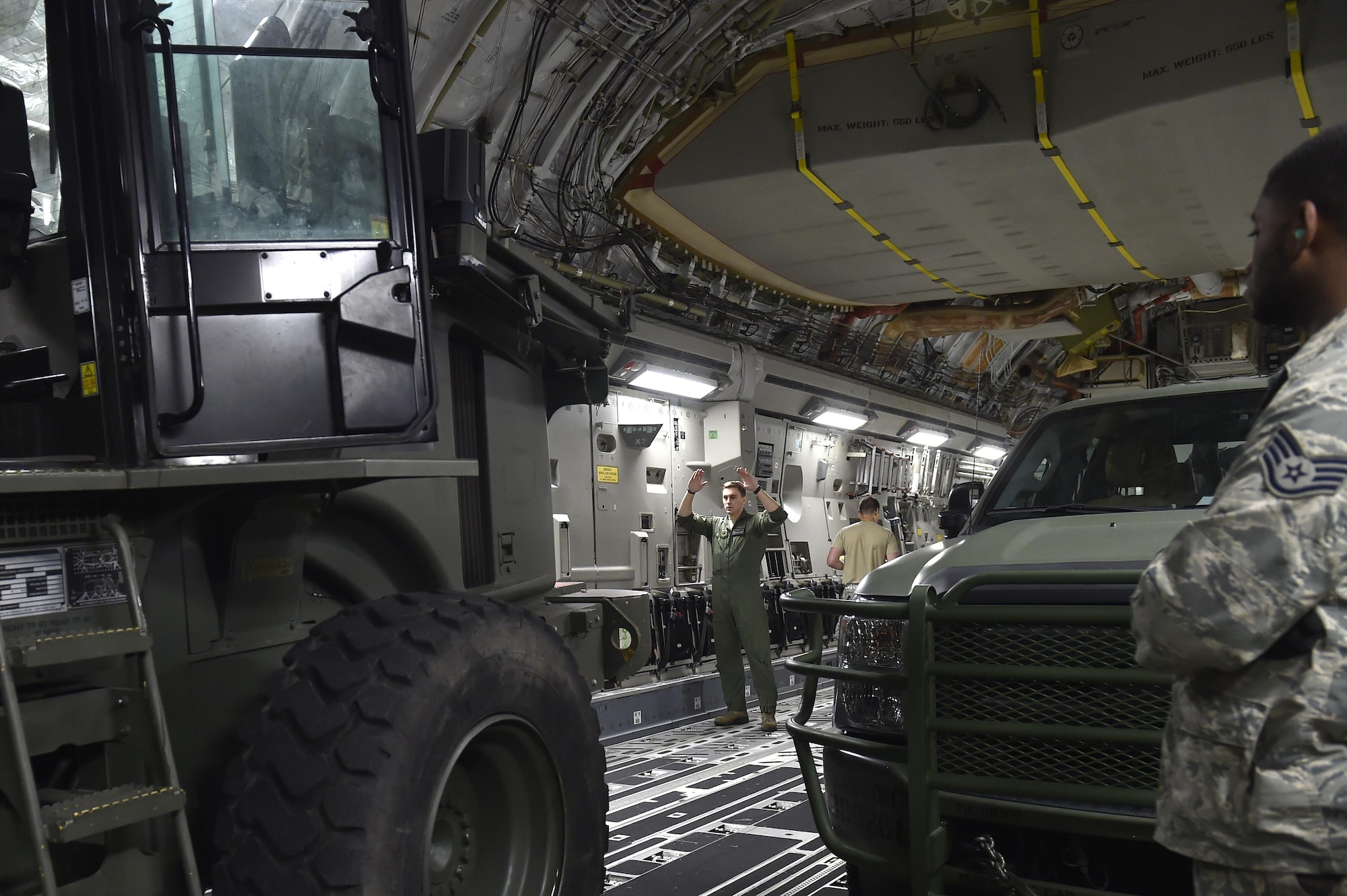 Staff Sgt. Dungan Farver, 16th Airlift Squadron loadmaster, signals a 10K All Terrain forklift onto a C-17 Globemaster III aircraft, Sep. 13, 2017, at Scott Air Force Base, Ill.   A 17-member contingency response team from the 821st Contingency Response Group from Travis Air Force Base, Calif., deployed to Homestead Air Reserve Base, Fla., to augment the 439th Airlift Wing airfield capabilities in support of Hurricane Irma relief efforts.  (U.S. Air Force photo by Tech. Sgt. Liliana Moreno/Released)
