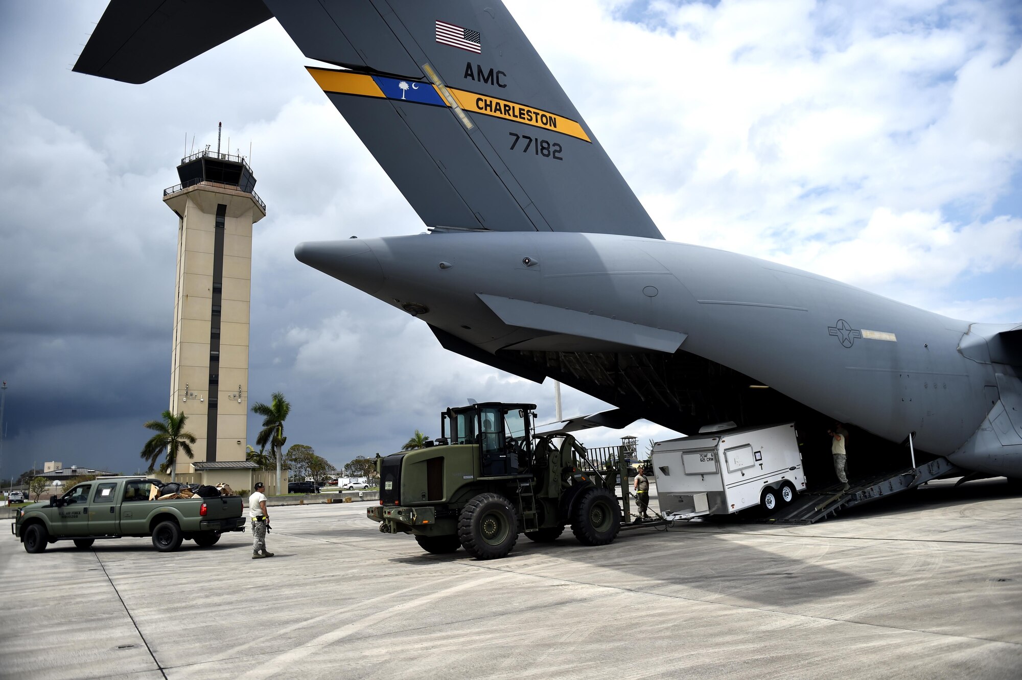 Contingency Response Airmen offload cargo from a C-17 Globemaster III, Sep. 13, 2017, at Homestead Air Reserve Base, Fla.  A 17-member contingency response team from the 821st Contingency Response Group from Travis Air Force Base, Calif., deployed to Homestead ARB to augment the 439th Airlift Wing airfield capabilities in support of Hurricane Irma relief efforts.  (U.S. Air Force photo by Tech. Sgt. Liliana Moreno/Released)