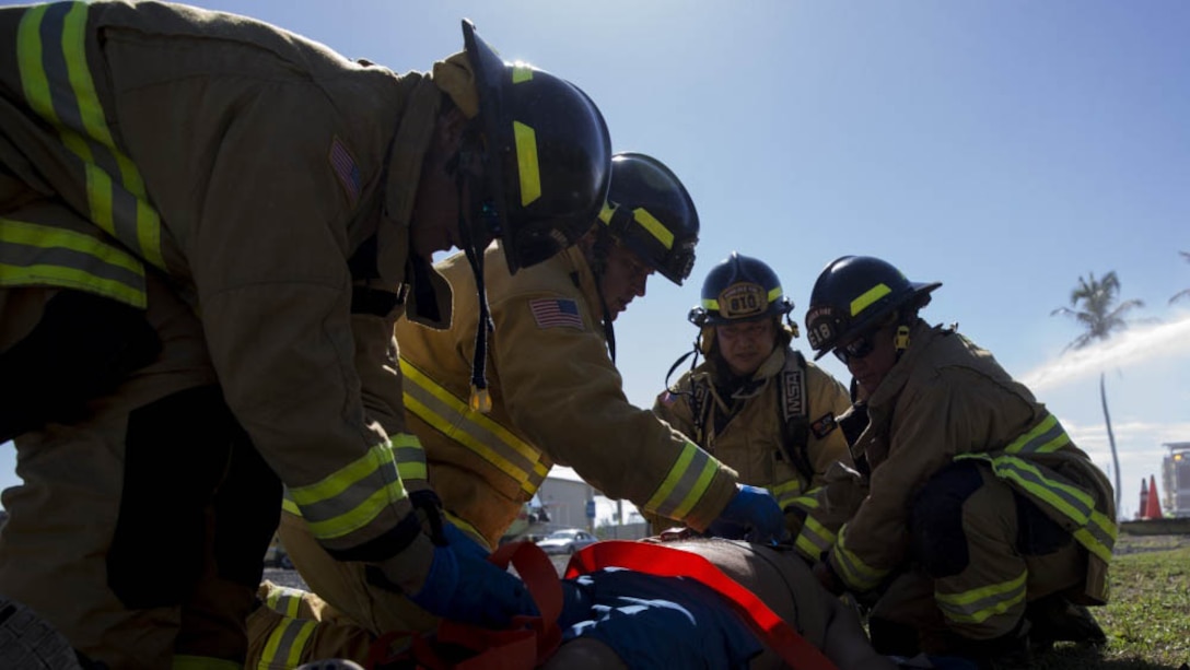 First responders with the Marine Corps Base Hawaii Fire Department secure a simmulated victim to a stretcher during the Anti-Terrorism/Force Protection Exercise Lethal Breeze aboard MCBH, Sept. 12, 2017.