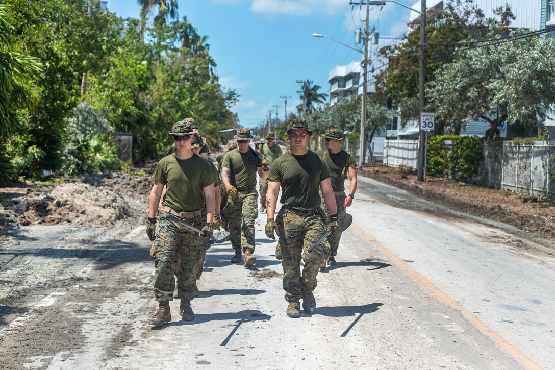A group of Marines walks down the street.