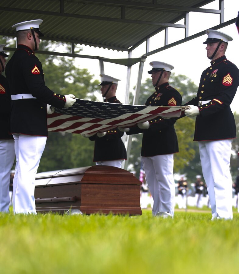 Marine Corps Body Bearers with Bravo Company, Marine Barracks Washington D.C., prepare to fold the National Flag during a full honors funeral at Arlington National Cemetery, Va., Sept. 13, 2017. Marine Barracks Washington is home to the Marines who provide support for all Marine Corps funerals and many high-ranking government officials funerals within the Capitol area. (Official U.S. Marine Corps photo by Lance Cpl. Damon Mclean/Released)