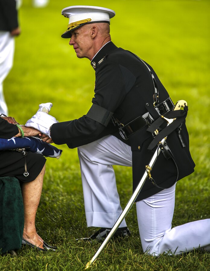 Colonel Tyler J. Zagurski, commanding officer, Marine Barracks Washington D.C., presents the National Flag to the next of kin during a full honors funeral at Arlington National Cemetery, Va., Sept. 13, 2017. Marine Barracks Washington is home to the Marines who provide support for all Marine Corps funerals and many high-ranking government officials funerals within the Capitol area. (Official U.S. Marine Corps photo by Lance Cpl. Damon Mclean/Released)
