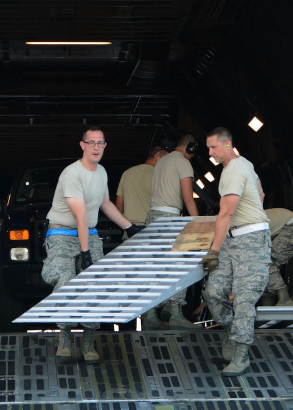 Westover aerial porters, from both the 42nd and 58th squadrons, help unload supplies and equpiment that will aid in Hurricane Irma relief efforts.
