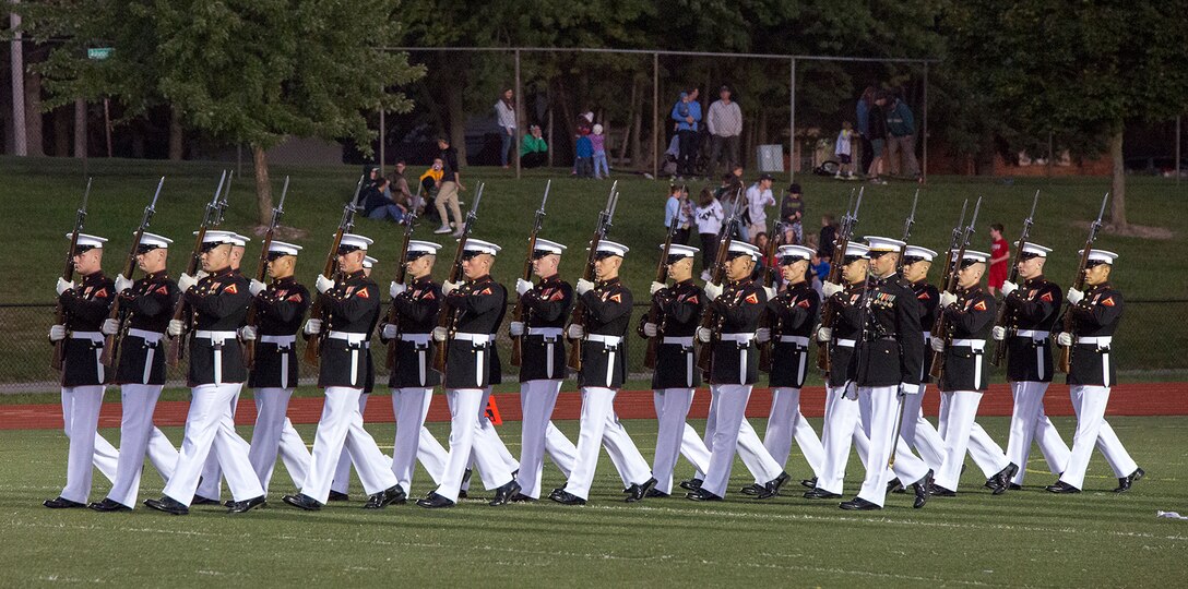 Marines with the U.S. Marine Corps Silent Drill Platoon perform during a halftime show for a high school football game at Rochester Hills high school, Rochester Hills, MI., Sept. 8, 2017. Marines with the Silent Drill Platoon and U.S. Marine Corps Color Guard visited local high schools in the greater Detroit area throughout Marine Week to display the pride, professionalism, and Esprit de Corps of the Marine Corps and afforded students the opportunity to interact with both teams. (Official U.S. Marine Corps photo by Cpl. Robert Knapp/Released)