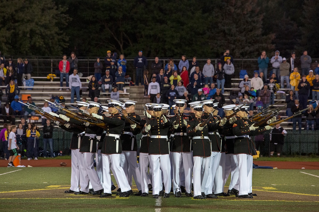 Marines with the U.S. Marine Corps Silent Drill Platoon execute their “bursting bomb” sequence during a halftime show for a high school football game at Rochester Hills high school, Rochester Hills, MI., Sept. 8, 2017. Marines with the Silent Drill Platoon and U.S. Marine Corps Color Guard visited local high schools in the greater Detroit area throughout Marine Week to display the pride, professionalism, and Esprit de Corps of the Marine Corps and afforded students the opportunity to interact with both teams. (Official U.S. Marine Corps photo by Cpl. Robert Knapp/Released)