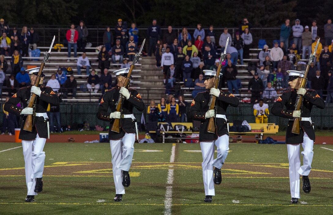 Marines with the U.S. Marine Corps Silent Drill Platoon execute their “long line” sequence during a halftime show for a high school football game at Rochester Hills high school, Rochester Hills, MI., Sept. 8, 2017. Marines with the Silent Drill Platoon and U.S. Marine Corps Color Guard visited local high schools in the greater Detroit area throughout Marine Week to display the pride, professionalism, and Esprit de Corps of the Marine Corps and afforded students the opportunity to interact with both teams. (Official U.S. Marine Corps photo by Cpl. Robert Knapp/Released)