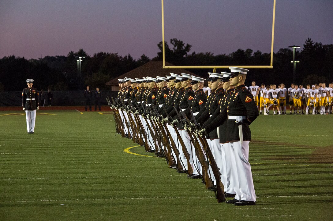 Marines with the U.S. Marine Corps Silent Drill Platoon execute their “long line” sequence during a halftime show for a high school football game at Rochester Hills high school, Rochester Hills, MI., Sept. 8, 2017. Marines with the Silent Drill Platoon and U.S. Marine Corps Color Guard visited local high schools in the greater Detroit area throughout Marine Week to display the pride, professionalism, and Esprit de Corps of the Marine Corps and afforded students the opportunity to interact with both teams. (Official U.S. Marine Corps photo by Cpl. Robert Knapp/Released)