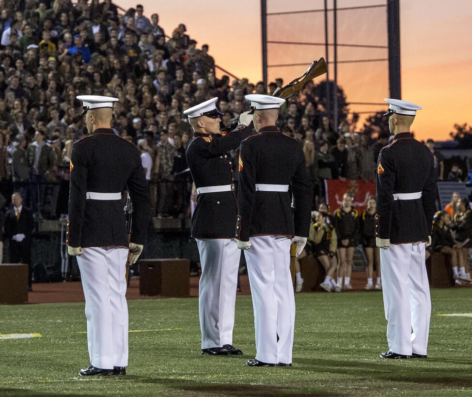 Corporal Jarris Wade, rifle inspector, U.S. Marine Corps Silent Drill Platoon, and Lance Cpl. Ryan Watkins, rifle inspection team, SDP, execute a rifle inspection during a halftime show for a high school football game at Rochester Hills high school, Rochester Hills, MI., Sept. 8, 2017. Marines with the Silent Drill Platoon and U.S. Marine Corps Color Guard visited local high schools in the greater Detroit area throughout Marine Week to display the pride, professionalism, and Esprit de Corps of the Marine Corps and afforded students the opportunity to interact with both teams. (Official U.S. Marine Corps photo by Cpl. Robert Knapp/Released)