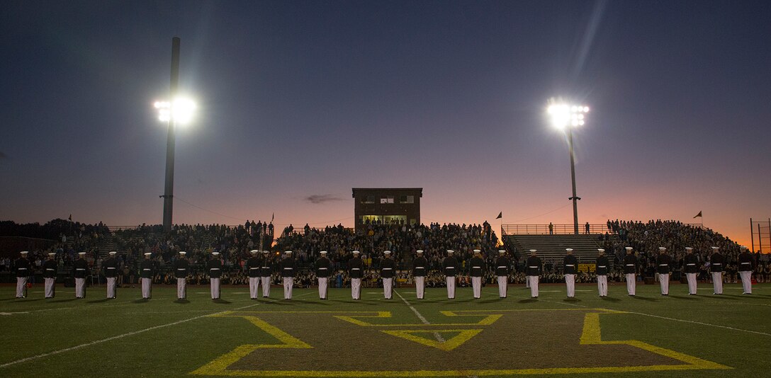 Marines with the U.S. Marine Corps Silent Drill Platoon execute their “long line” sequence during a halftime show for a high school football game at Rochester Hills high school, Rochester Hills, MI., Sept. 8, 2017. Marines with the Silent Drill Platoon and U.S. Marine Corps Color Guard visited local high schools in the greater Detroit area throughout Marine Week to display the pride, professionalism, and Esprit de Corps of the Marine Corps and afforded students the opportunity to interact with both teams. (Official U.S. Marine Corps photo by Cpl. Robert Knapp/Released)