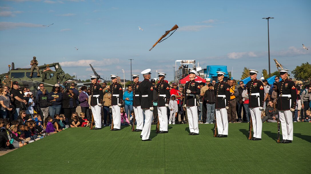 Corporal Jarris Wade, rifle inspector, U.S. Marine Corps Silent Drill Platoon, and Lance Cpl. Ryan Watkins, rifle inspection team, SDP, execute a rifle inspection during a performance at the static display section of Marine Week, Detroit, MI. Sept. 9, 2017. Marine Week, hosted by the Marine Corps in one city per year, is a celebration of community, country and Corps that allows the public to connect with Marines through live-demonstrations, hands-on static displays and several other interactive events. (Official U.S. Marine Corps photo by Cpl. Robert Knapp/Released)