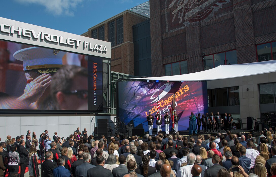 The U.S. Marine Corps Color Guard presents the National Ensign and the Marine Corps Battle Colors during the playing of the national anthem to kick-off a ribbon cutting ceremony for the Little Caesars Arena in support of Marine Week, Detroit, MI., Sept. 5, 2017. Marine Week, hosted by the Marine Corps in one city per year, is a celebration of community, country and Corps that allows the public to connect with Marines through live-demonstrations, hands-on static displays and several other interactive events. (Official U.S. Marine Corps photo by Cpl. Robert Knapp/Released)