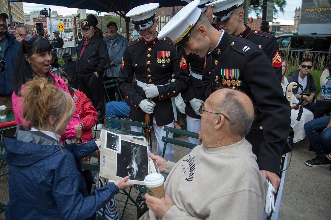 Marines with the U.S. Marine Corps Silent Drill Platoon meet and interact with former SDP member and Vietnam veteran, Lt. Gerald Flick, U.S. Marine Corps retired, before the opening ceremony of Marine Week, Detroit, MI., Sept. 6, 2017. Flick’s daughter surprised him for his upcoming 80th birthday in October by bringing him out to see SDP perform during the opening ceremony at Campus Martius in downtown Detroit. (Official U.S. Marine Corps photo by Cpl. Robert Knapp/Released)