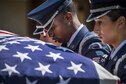 Senior Airman Antonio Samuels, 453rd Electronic Warfare Squadron, bows his head as he and fellow Airmen carry a casket out of a hearse during an honor guard graduation ceremony at Eglin Air Force Base, Fla., Sept. 8, 2017. The graduation performance included flag detail, rifle volley, pall bearers and bugle demonstrations. (U.S. Air Force photo by Samuel King Jr.)
