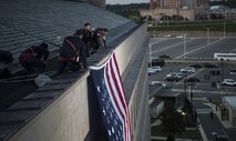 A large American flag is unfurled over the west side of the Pentagon at sunrise in Arlington, Va., Sept. 11, 2017. During the Sept. 11, 2001 attacks, 184 people were killed at the Pentagon. (DoD photo by Tech. Sgt. Brigitte N. Brantley)
