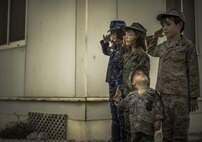 A deployed U.S. Air Force family honors the anniversary of 9/11 during a retreat ceremony at Al Udeid Air Base, Qatar, Sept. 11, 2017. The 9/11 retreat was held in honor of those who lost their lives in the 2001 terrorist attacks, and to remember those who gave their lives since that day. (U.S. Air Force photo by Staff Sgt. Trevor T. McBride)