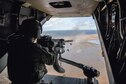 An air commando from the 7th Special Operations Squadron fires a .50 caliber machine gun, aboard a CV-22 Osprey, during a flight around southern England, Sept. 11, 2017. The Osprey flew to a range where the crew sighted, loaded and ran through technical and tactical procedures to re-qualify on the .50 caliber weapons system. (U.S. Air Force photo by Staff Sgt. Philip Steiner)