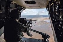 An air commando from the 7th Special Operations Squadron fires a .50 caliber machine gun, aboard a CV-22 Osprey, during a flight around southern England, Sept. 11, 2017. The Osprey flew to a range where the crew sighted, loaded and ran through technical and tactical procedures to re-qualify on the .50 caliber weapons system. (U.S. Air Force photo by Staff Sgt. Philip Steiner)