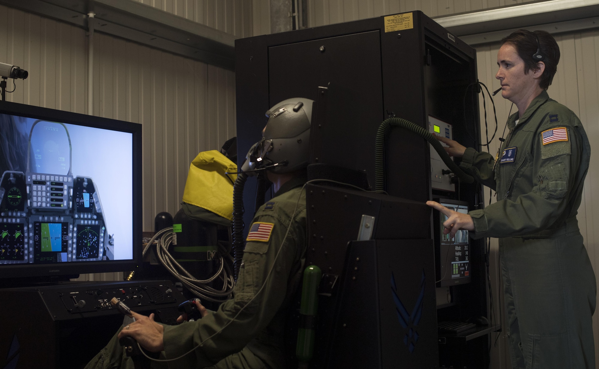 U.S. Air Force Capt. Charity Bolling, 86th Aerospace Medicine Squadron Aerospace Physiology flight chief, monitors an 86th Operations Support Squadron pilot as he flies a simulated aircraft while hooked up to a reduced oxygen breathing device on Ramstein Air Base, Germany, Sept. 13, 2017. The purpose of the ROBD is to familiarize air crew personnel with effects of hypoxia, the lack of oxygen at high altitudes, and teach them how to mitigate the symptoms. (U.S. Air Force photo by Senior Airman Tryphena Mayhugh)