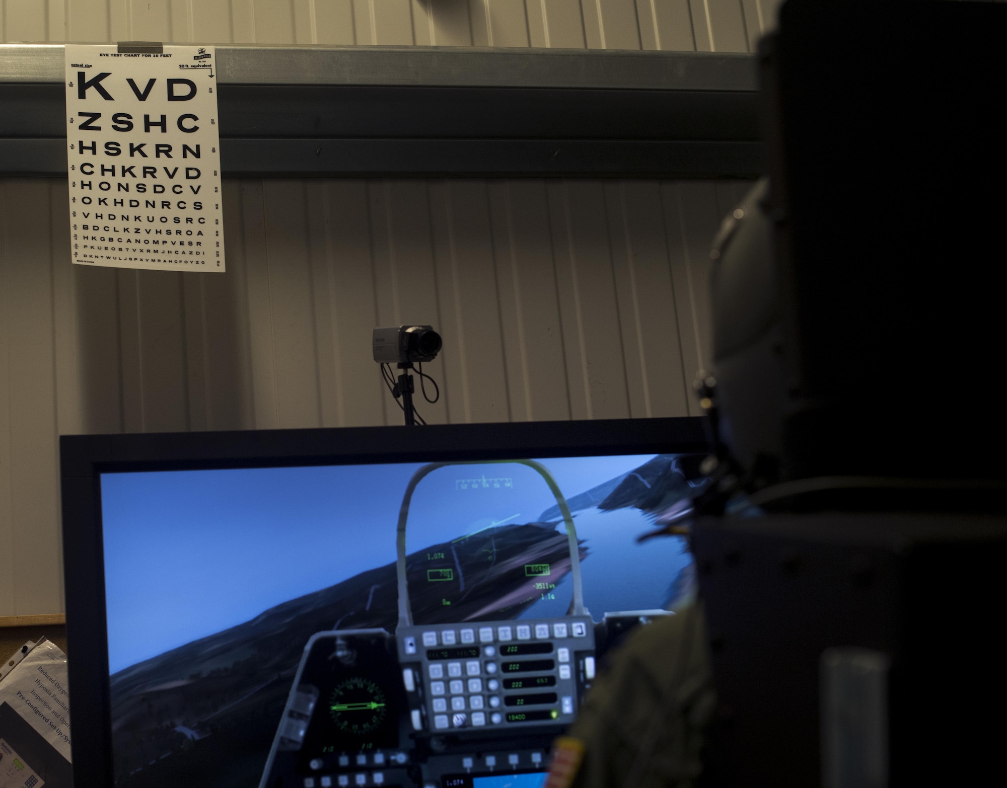 A U.S. Air Force 86th Operations Support Squadron pilot views an eye chart as he flies a simulated aircraft while hooked up to the 86th Aerospace Medical Squadron Aerospace Physiology’s reduced oxygen breathing device on Ramstein Air Base, Germany, Sept. 13, 2017. The purpose of the ROBD is to allow air crew the opportunity to experience the effects of hypoxia, the lack of oxygen in high altitudes, such as visual impairment. (U.S. Air Force photo by Senior Airman Tryphena Mayhugh)