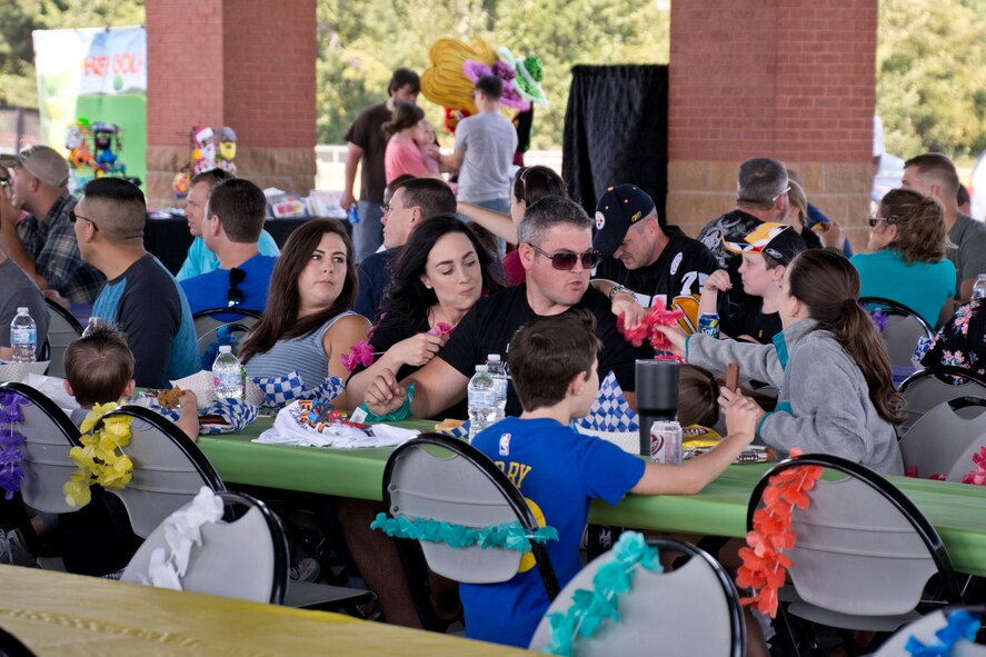 Airmen, co-workers and family members eat lunch at the 913th Airlift Group’s “Family Day” celebration at Little Rock Air Force Base, Ark., Sept. 10, 2017. Approximately 750 people participated in the annual event, which promotes taking care of the unit’s family members. (U.S. Air Force photo by Master. Sgt. Jeff Walston/Released)