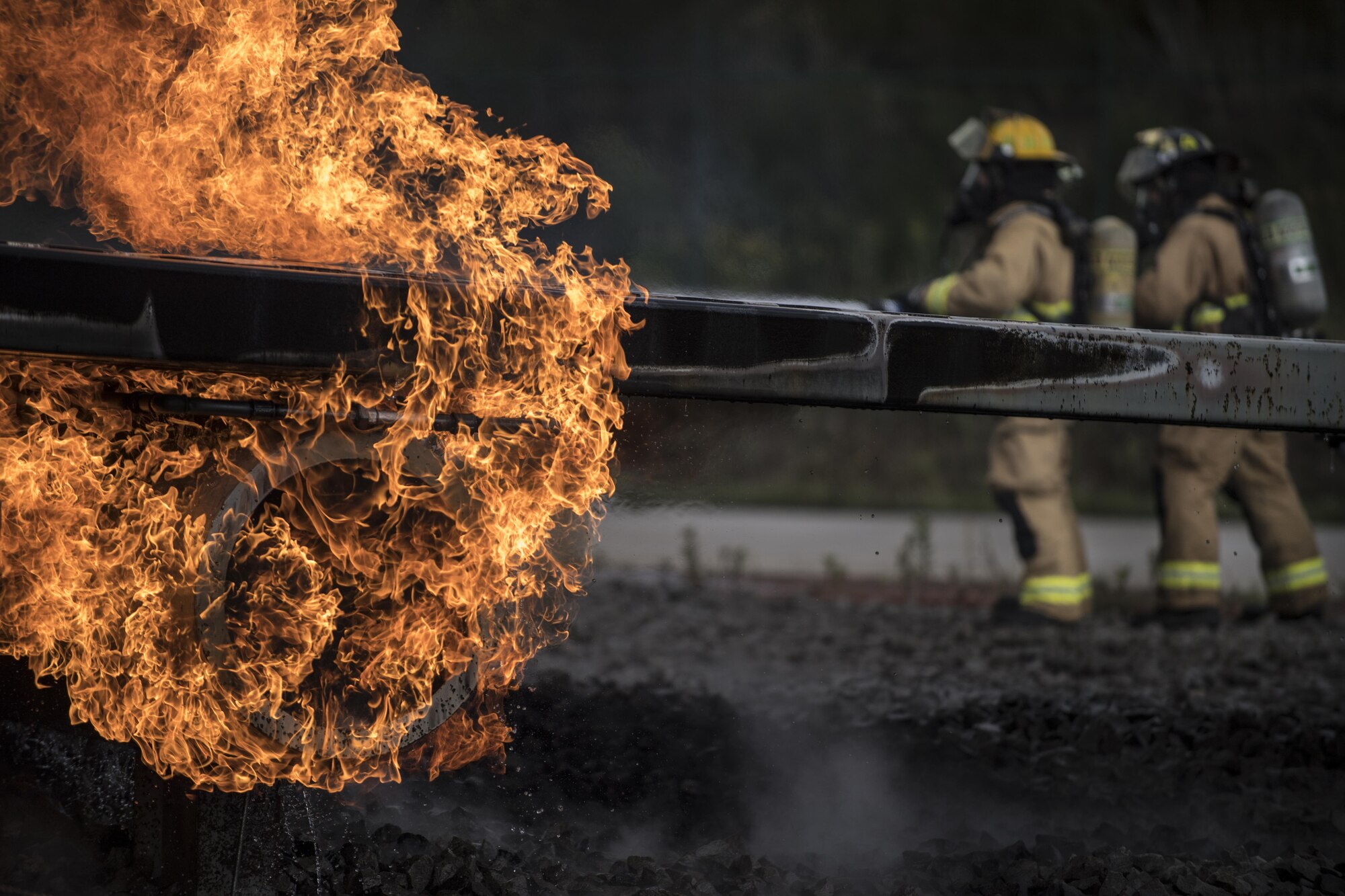 U.S. Air Force firefighters assigned to various bases put out a fire as part of a 10-day Silver Flag exercise at the 86th Civil Engineer Squadron Fire and Emergency Services Training Area on Ramstein Air Base, Germany, Sept. 14, 2017.
