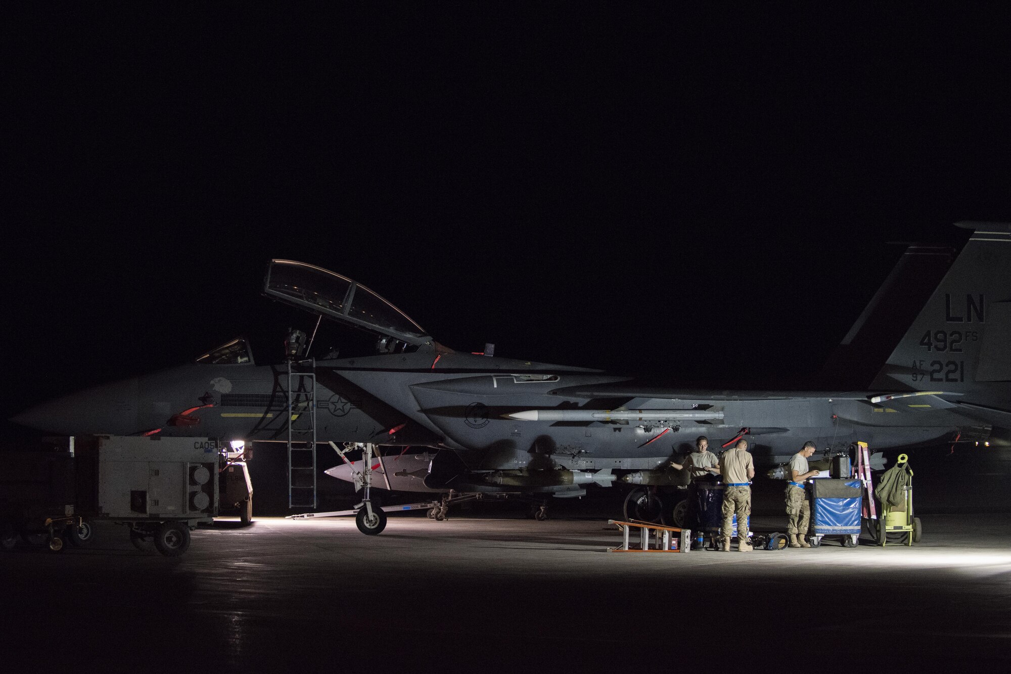 Airmen from the 332nd Expeditionary Maintenance Squadron weapons flight, finish loading munitions on an F-15E Strike Eagle, August 12, 2017, in Southwest Asia. The weapons flight works around the clock to ensure bombs and missiles are loaded onto F-15E Strike Eagles and that the weapons systems function properly. (U.S. Air Force photo/Senior Airman Damon Kasberg)