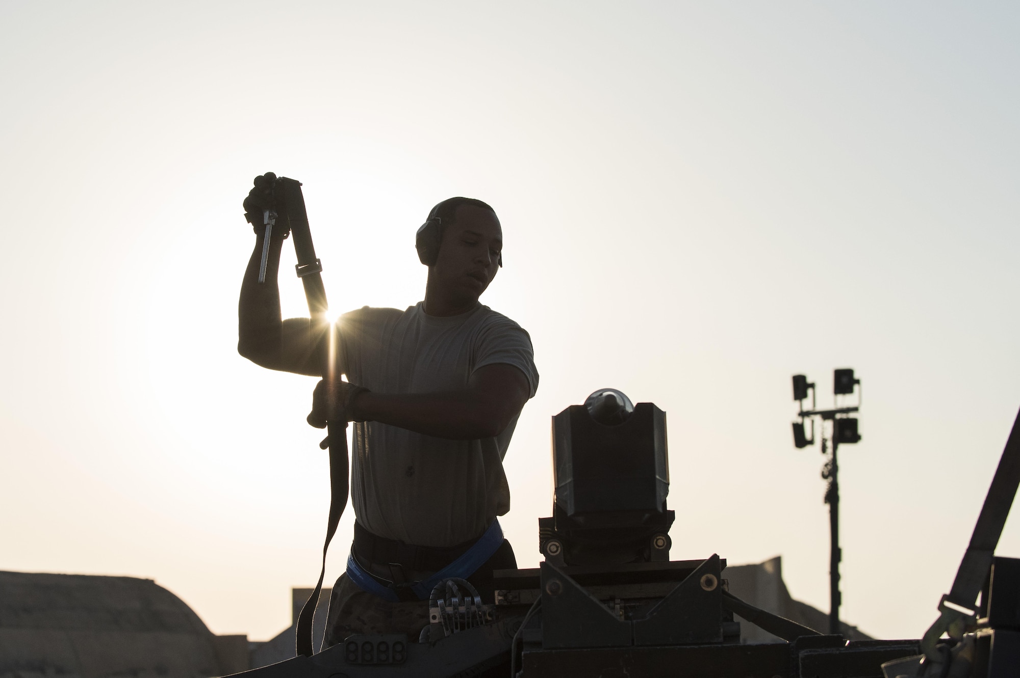 Tech. Sgt. Keith Rochford, 332nd Expeditionary Maintenance Squadron weapons load crew chief, secures a bomb to a lift truck before loading it on an F-15E Strike Eagle, August 13, 2017, in Southwest Asia. Due to the size and weight of the bombs, they must be loaded using a lift truck to prevent injuries and damage to the munitions. (U.S. Air Force photo/Senior Airman Damon Kasberg)